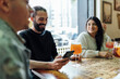 © Ezequiel Gim√©nez/Westend61 - Male and female friends with drinks at table in bar