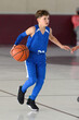 © Joe - Young athletic boy playing in a game of basketball