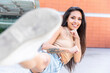 © William Perugini/Westend61 - Young woman smiling while stretching leg outdoors