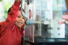 4 Year Old Mixed Race Boy Presses A Souvenir Penny At A Local Sydney Tourist Attraction
