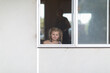 © Caro Telfer/Austockphoto - Child looking out window through flyscreen