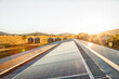 © Clare Seibel-Barnes/Austockphoto - Solar panels on a shed roof generating energy with sunlight lens flare