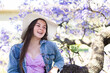 © Clare Seibel-Barnes/Austockphoto - Happy teenage girl wearing a hat for sun protection sitting in a jacaranda tree laughing