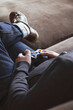 © Jodie Johnson/Austockphoto - Guy using game controller on couch with space for text