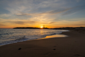 Sticker - sunset on the Playa de Maria Sucia Beach with the Cape Trafalgar Lighthouse in the background