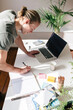 © Jodie Johnson/Austockphoto - Blond young man writing in a notebook on a desk from above