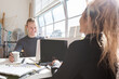 © Jodie Johnson/Austockphoto - Coworkers at a shared desk in a creative studio workplace