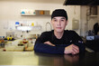© Sammy Bailey/Austockphoto - Multicultural Asian chef in Thai small business restaurant