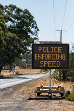 Traffic Safety Sign With 'Police Enforcing Speed' Illuminated