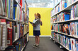 © Kathryn Jewkes/Austockphoto - Girl reading a book in a library