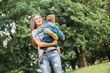 © zadorozhna - Mother play with son in the park.