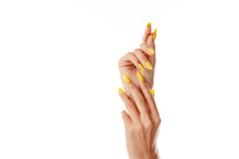 Closeup Shot Of A Female's Hands With Yellow Nail Polish On A White Background