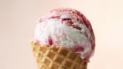 Poster - close up of rotating vanilla and strawberry ice cream in waffle scoop