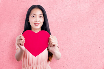 Poster - Asian woman holding the red heart