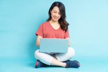 Wall Mural - Beautiful Asian woman sitting working with laptop