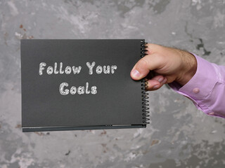 Wall Mural - Motivational concept meaning Follow Your Goals with sign on the page.