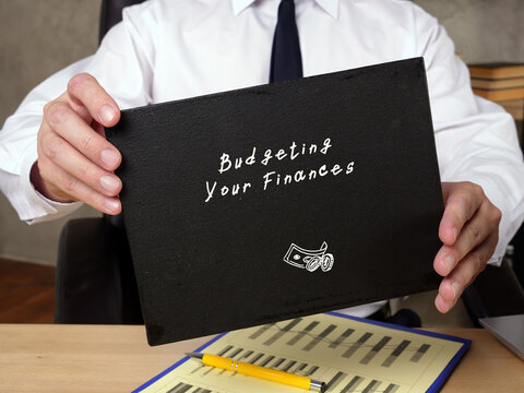 Business concept about Budgeting Your Finances r with phrase on the sheet.
