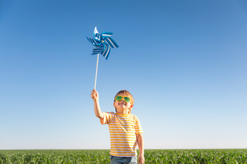 Wall Mural - Happy child playing outdoors in spring field