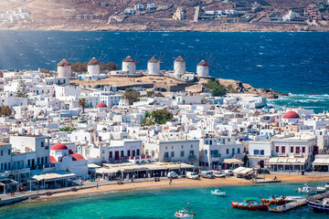 Wall Mural - Beautiful view to the traditional windmills above the town of Mykonos island, Cyclades, Greece, with the whitewashed houses and turquoise sea