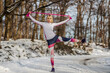 © Dusan Petkovic - Slim sportswoman doing exercises with power rubber while standing in nature at snowy winter day. Exercise equipment, winter fitness