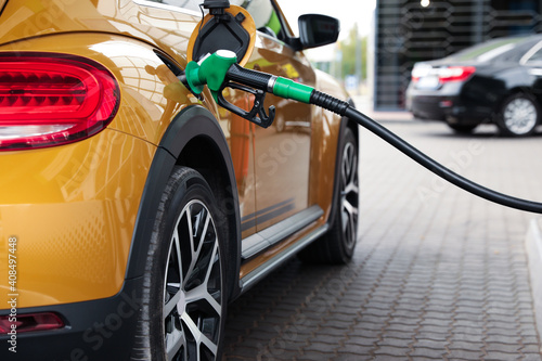 Refueling modern car at gas filling station, closeup © New Africa