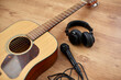© Syda Productions - leisure, music and musical instruments concept - close up of acoustic guitar, microphone and headphones on black table