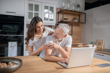 Woman with coffee and man with laptop