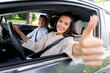 © Syda Productions - driver courses and people concept - car driving school instructor and young woman showing thumbs up to drive