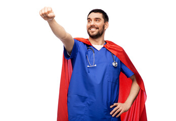 Fototapete - healthcare, profession and medicine concept - happy smiling doctor or male nurse in blue uniform and red superhero cape with stethoscope over white background