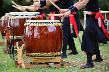 Taiko drummers drumming on Japanese Drums