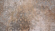 Old brown gray rusty vintage worn shabby patchwork damask motif tiles stone concrete cement wall texture background banner
