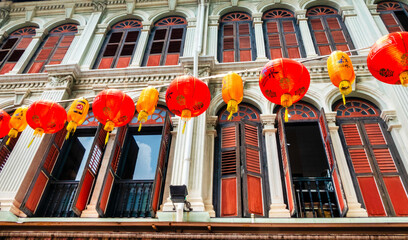 Wall Mural - Building facade with a row of Chinese paper lanterns outside in Chinatown, Singapore.
