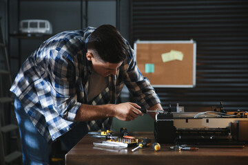 Poster - Repairman with screwdriver fixing modern printer in office