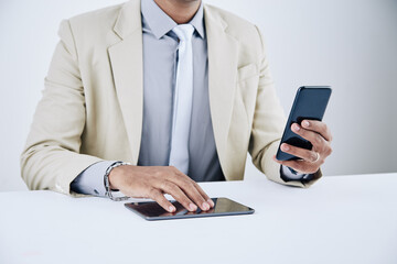 Wall Mural - hands of businessman checking text messages on smartphone and using mobile application on digital ta