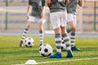 © matimix - Group of Boys on Soccer Training. Players Practicing European Football on a Summer Day. Children Playing Sports on School Grass Stadium
