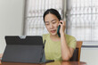 © bignai - Beautiful woman working on line and talking on cell phone and browsing in a laptop.
