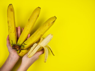 Ripe, tropical banana on a yellow background. Natural banana peel. Fruits.