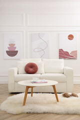 Wall Mural - Stylish living room interior with comfortable sofa and pictures