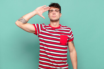 young man greeting the camera with a military salute in an act of honor and patriotism, showing respect