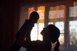 © Наталия Денисова - Silhouette of a young mother with her baby.