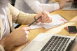 © master1305 - Nervous. Hands of colleagues working together in a office using modern devices during creative meeting. Stationery, laptop, documents during work. Concept of business, office, finance.