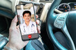 A smiling doctor posing with arms crossed is wearing a stethoscope on the smartphone screen. Telemedicine or telehealth concept.