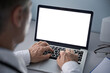 © insta_photos - Male doctor using laptop computer with blank white mockup screen technology for tele medicine medical healthcare tech website ad concept, video call e telehealth online appointment. Over shoulder view