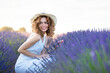 © Cavan Images - woman with curly hair wearing a hat in a lavender field
