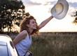 © Cavan Images - woman with curly hair wearing a hat in a lavender field