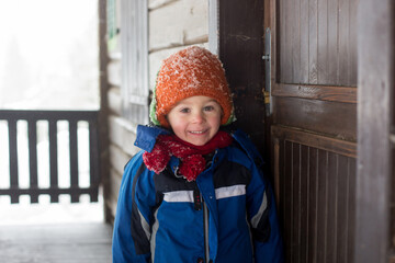 Poster - Beautiful toddler child, blond boy with cute hat, playing in the snow