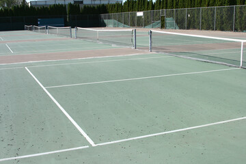 Wall Mural - Big and empty tennis court surrounded by trees