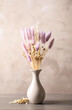 © New Africa - Dried flowers in vase on table against light grey background
