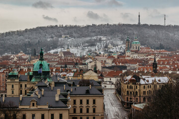 Winter view of the Lesser Town,Petrin Hill with lookout tower from Letna in Prague, Czech Republic.Prague panorama on cloudy day. Amazing European cityscape.Travel vacation background.Urban scenery.