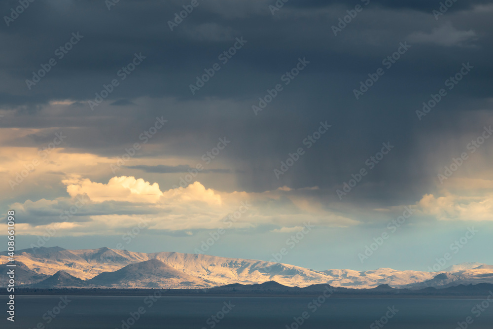 Distant view of Bolivian Cordillera Real over Lake Titicaca, Peru